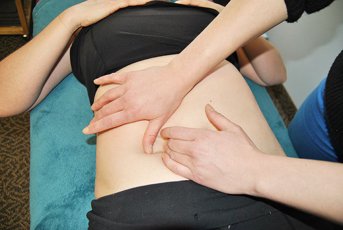 osteopath treating a patient with visceral Osteopathy